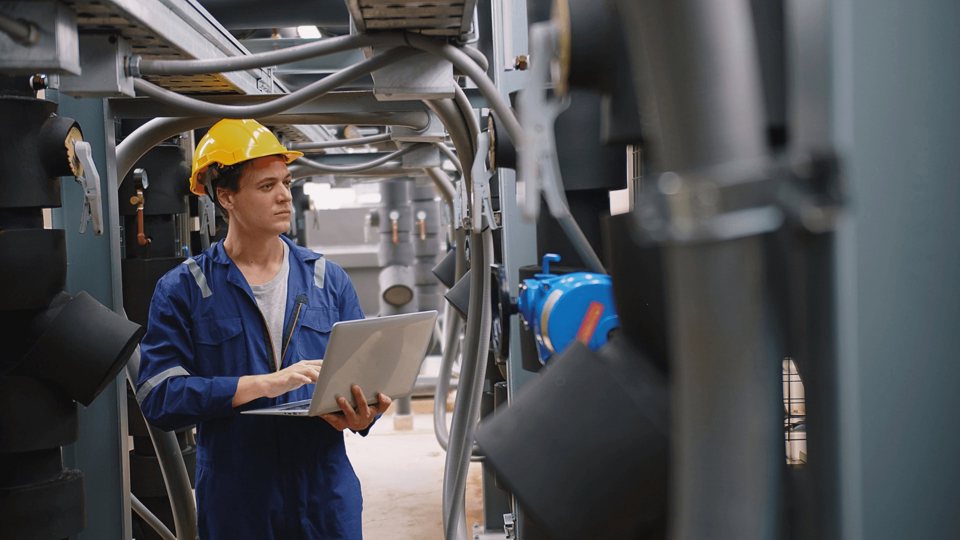 engineer using a laptop to check industrial air-cooling system